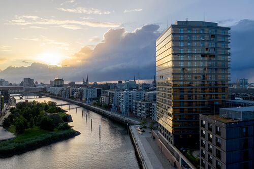 Exterior view of the Roots skyscraper in HafenCity at dusk
