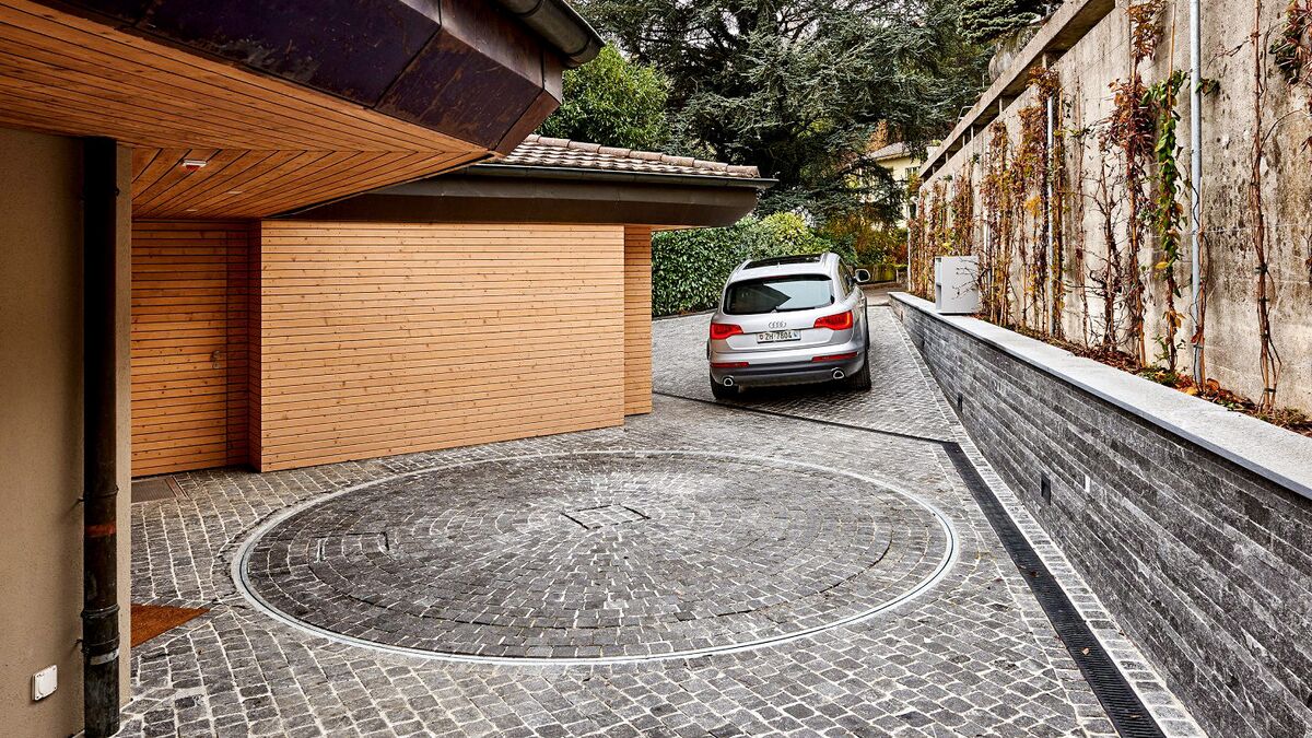 Car driving out of a courtyard