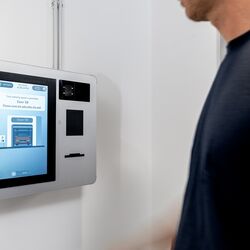 A person operates the control terminal of the WÖHR Combilift 542/543 to manage the parking process.