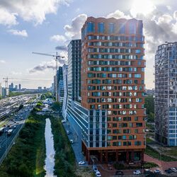 Modern urban district with high-rise buildings, green spaces, and good infrastructure.