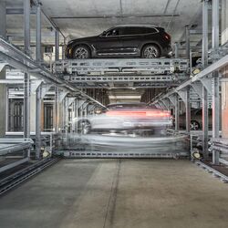 El coche está estacionado sobre una plataforma de aparcamiento en un sistema de estacionamiento automatizado.